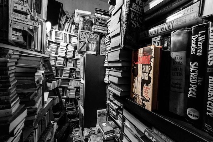 A photograph depicting a huge personal library of books including on those covering male hair